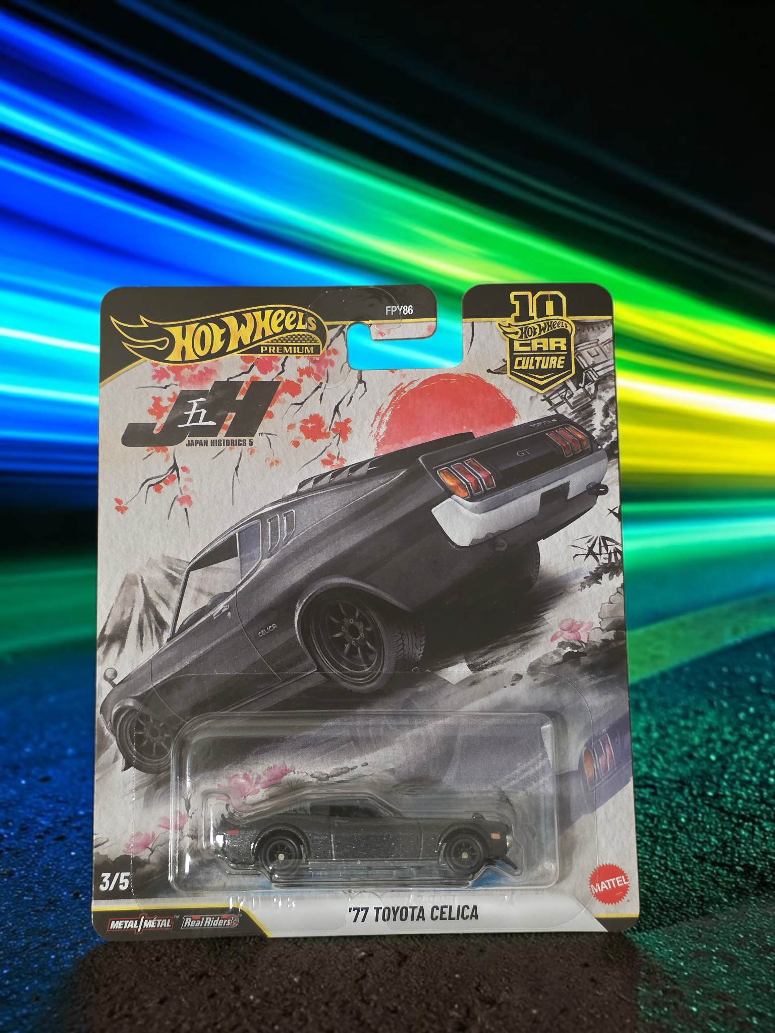 Winters & Johnson Diecast Hot Wheels Premium 77 Toyota Celica Japan Historics 3/5 diecast car in blister packaging