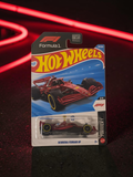 Winters & Johnson Diecast Hot Wheels Scuderia Ferrari HP Formula 1 car in red packaging on a dark neon background